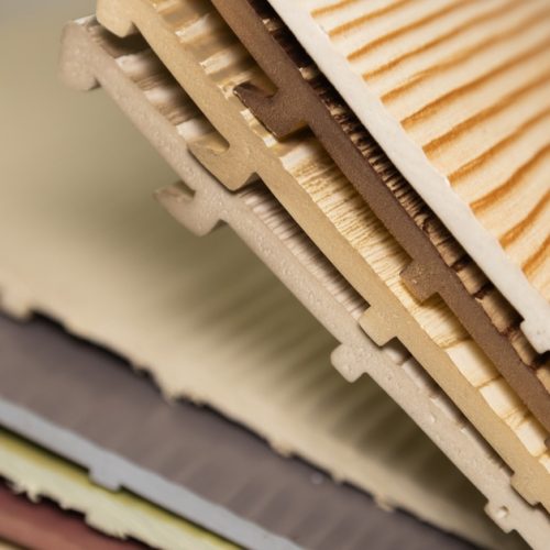A close-up of various sliding panels in different colors. They feature a woodgrain texture and pattern.